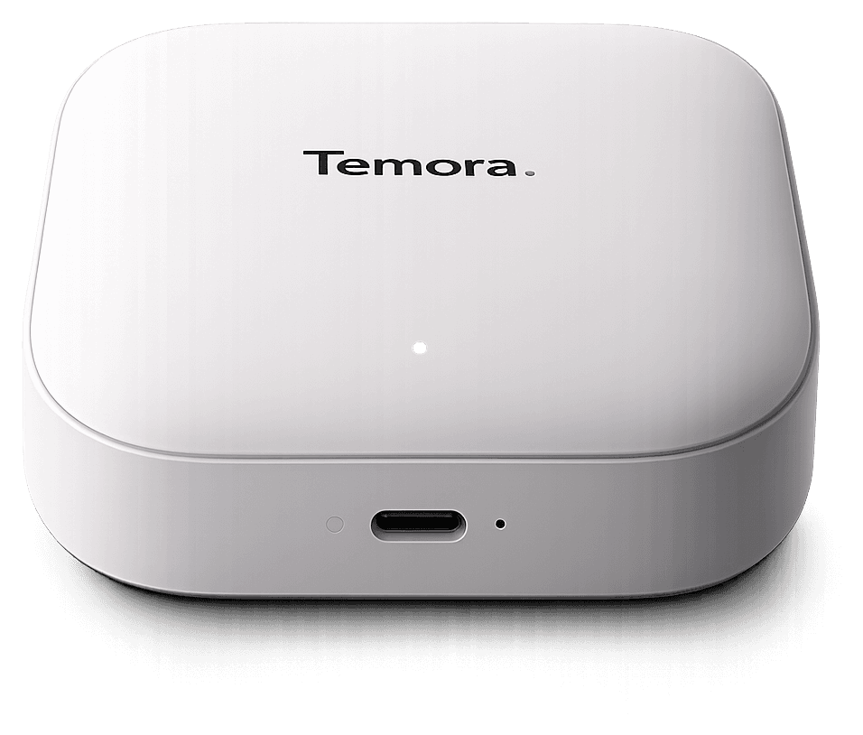 The TEMORA hub: a small white rounded box with the Temora mark on top and a USB-C port on the front